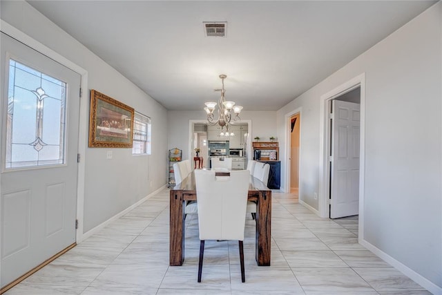 dining room featuring a notable chandelier