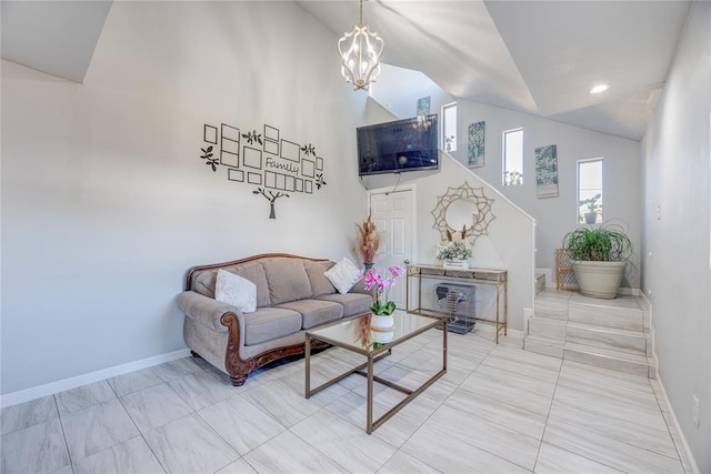 living room with a chandelier and high vaulted ceiling