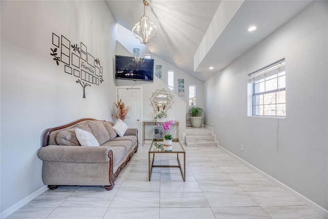 living room featuring an inviting chandelier and high vaulted ceiling