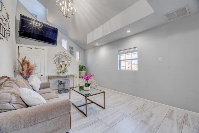 living room featuring vaulted ceiling and a chandelier