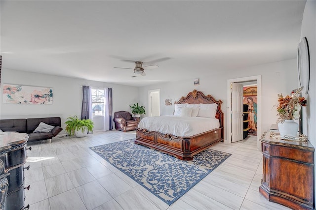 bedroom featuring a walk in closet and ceiling fan