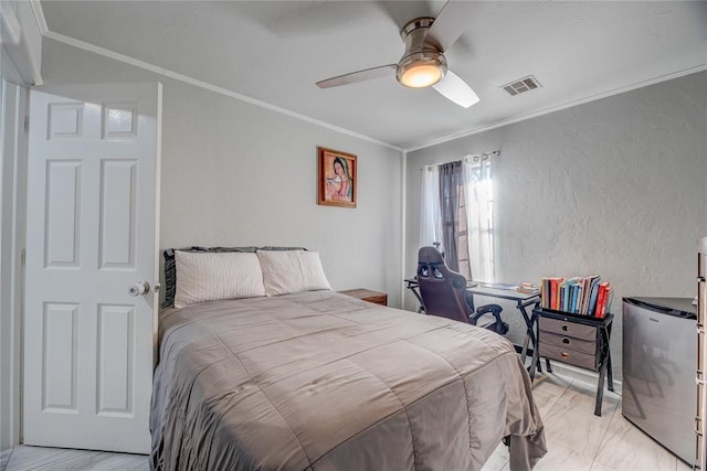 bedroom with crown molding, stainless steel refrigerator, and ceiling fan