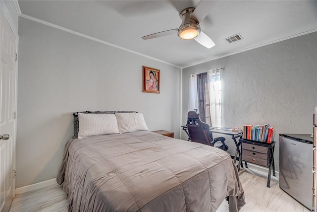 bedroom featuring ceiling fan, ornamental molding, and stainless steel fridge