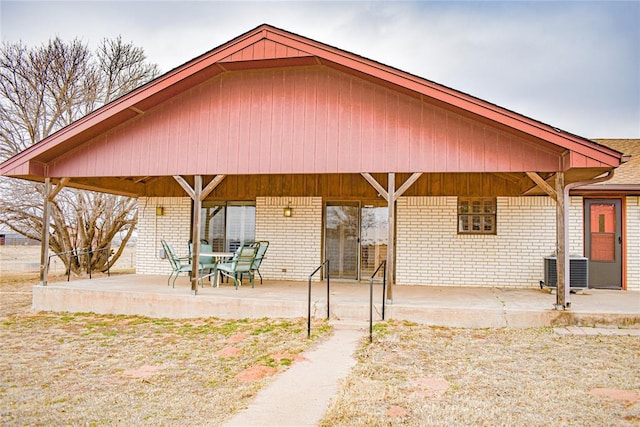 rear view of property featuring central air condition unit and a patio area