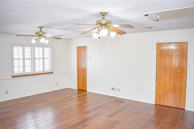 unfurnished room with dark hardwood / wood-style floors and a textured ceiling