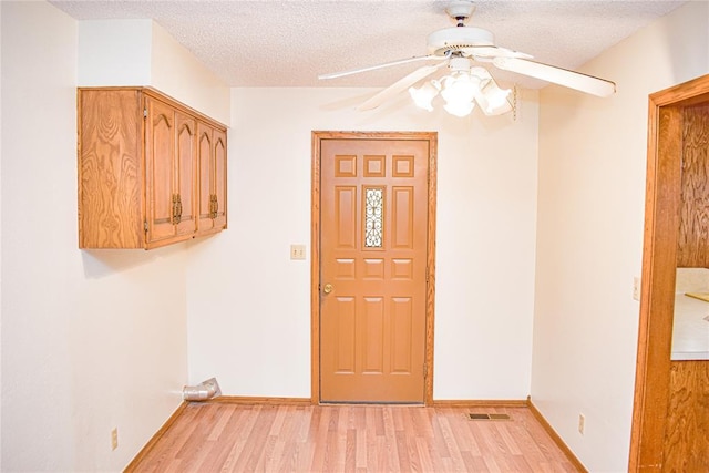 entryway featuring ceiling fan, a textured ceiling, and light hardwood / wood-style flooring