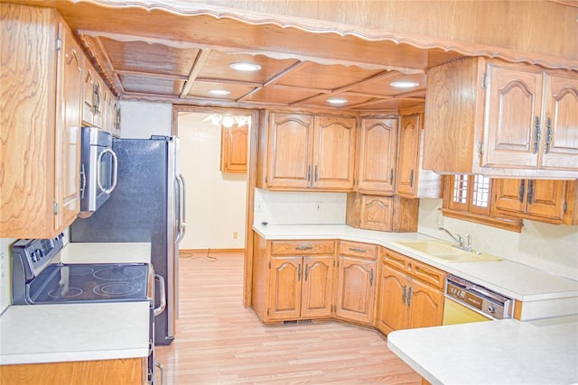 kitchen with sink, stainless steel appliances, and light wood-type flooring