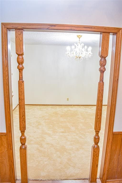 unfurnished room featuring carpet and a textured ceiling