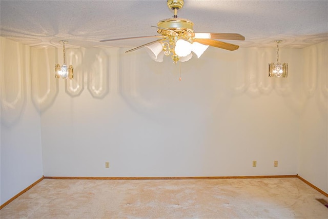 carpeted empty room with a textured ceiling and a chandelier