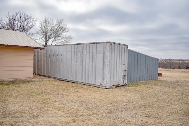 view of outbuilding with a lawn