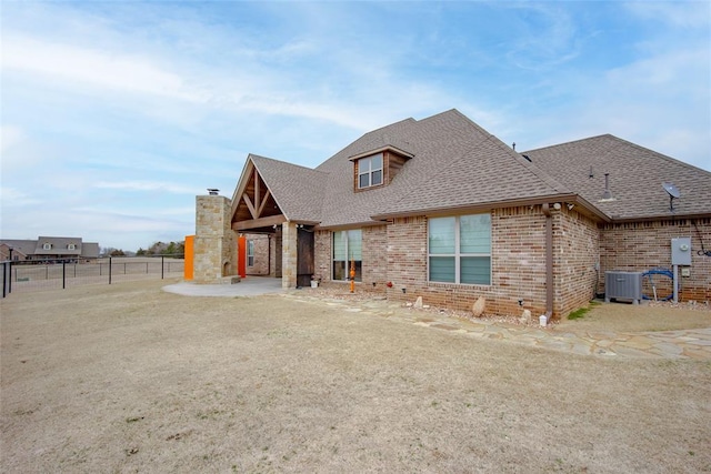 view of front of house with central AC unit and a patio area