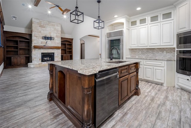 kitchen with white cabinetry, sink, decorative light fixtures, and appliances with stainless steel finishes