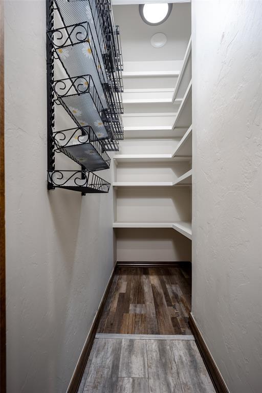 spacious closet featuring dark hardwood / wood-style floors