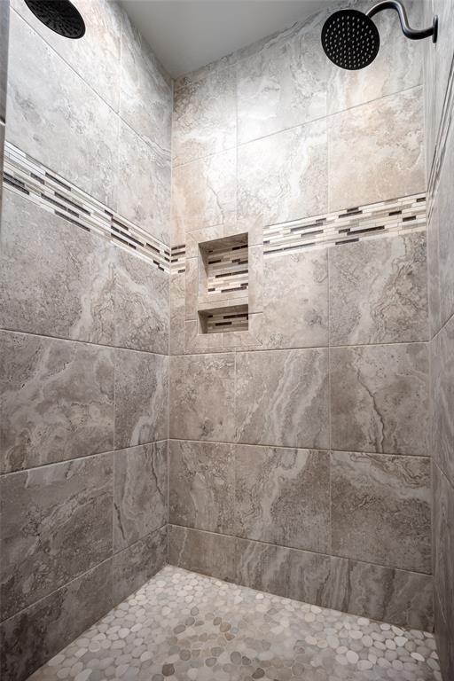 bathroom with tiled shower