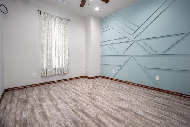 unfurnished room featuring hardwood / wood-style flooring and ceiling fan