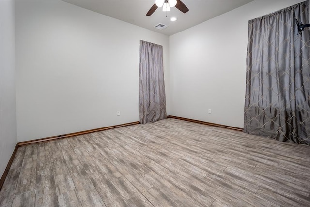 unfurnished room featuring hardwood / wood-style floors and ceiling fan