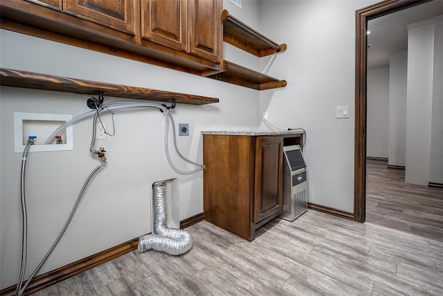 laundry room with cabinets, hookup for a washing machine, hookup for an electric dryer, and light wood-type flooring