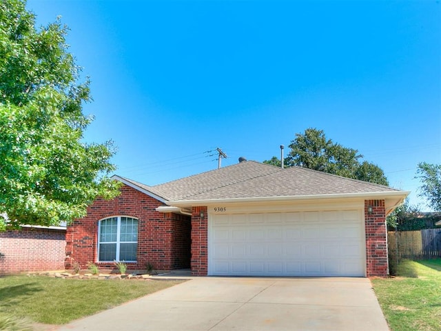 ranch-style home with a garage and a front yard