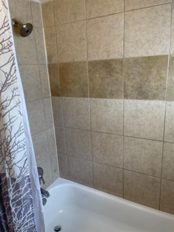 bathroom with shower / bathtub combination with curtain