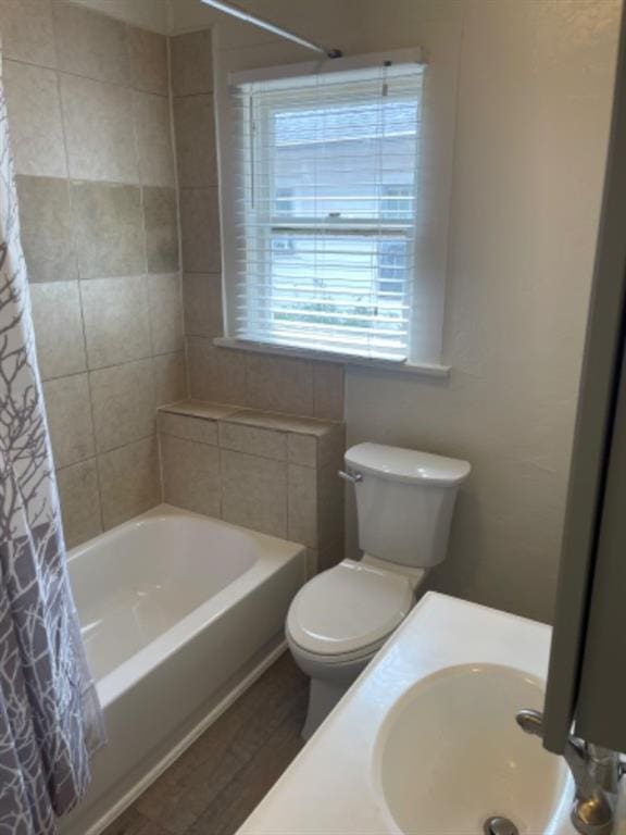 full bathroom with toilet, sink, and shower / bath combo