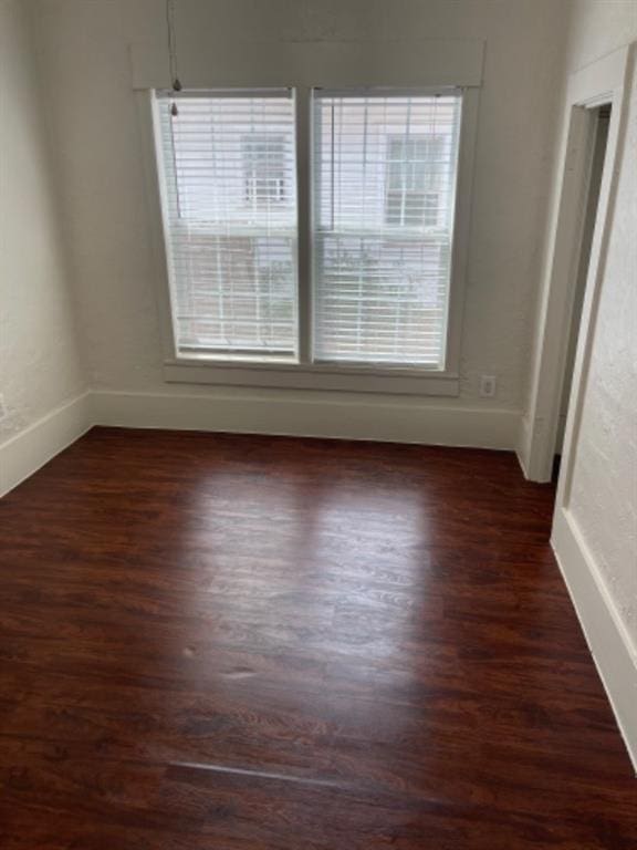 unfurnished room featuring dark hardwood / wood-style floors