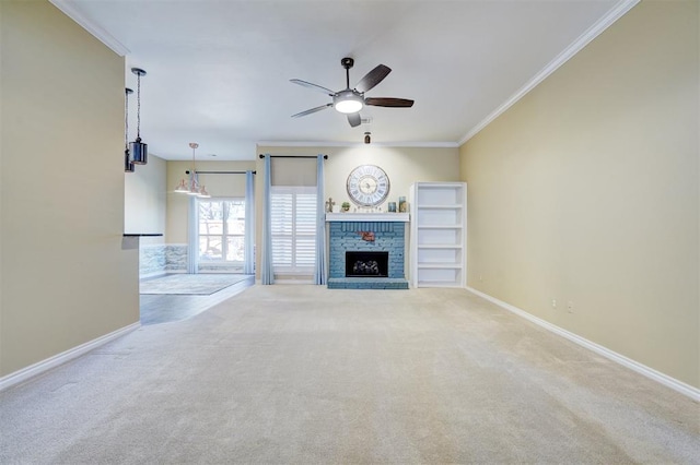 unfurnished living room featuring crown molding, ceiling fan, carpet flooring, and a brick fireplace