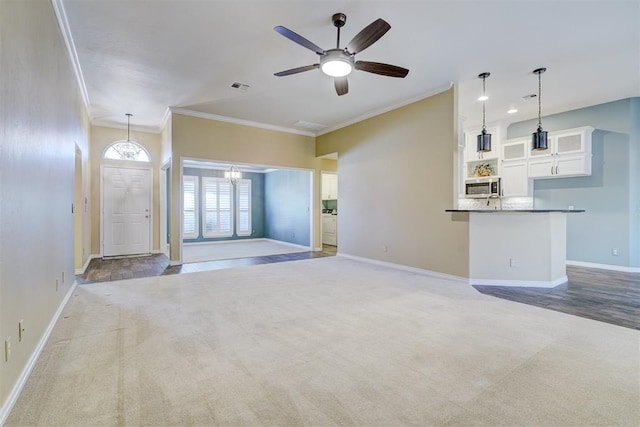 unfurnished living room featuring ornamental molding, light colored carpet, and ceiling fan