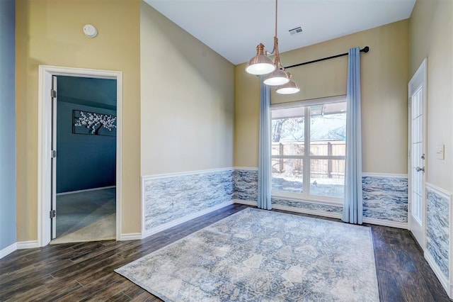 empty room featuring vaulted ceiling and dark wood-type flooring