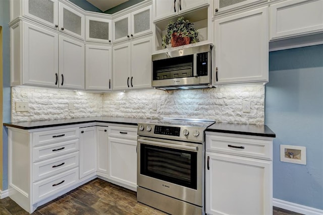 kitchen featuring backsplash, stainless steel appliances, and white cabinets