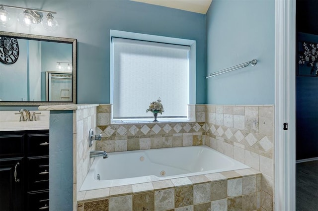 bathroom featuring vanity and tiled bath