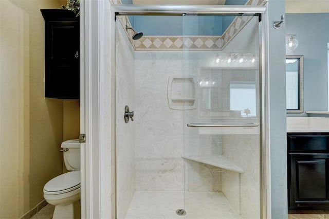 bathroom with vanity, an enclosed shower, and toilet