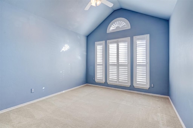 carpeted empty room featuring ceiling fan and vaulted ceiling