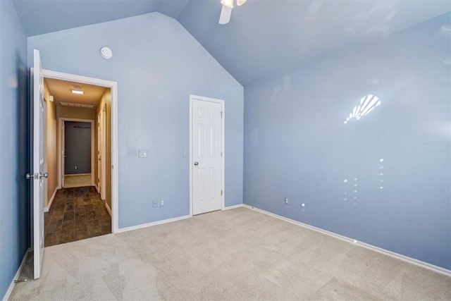 unfurnished bedroom featuring lofted ceiling, carpet floors, and ceiling fan