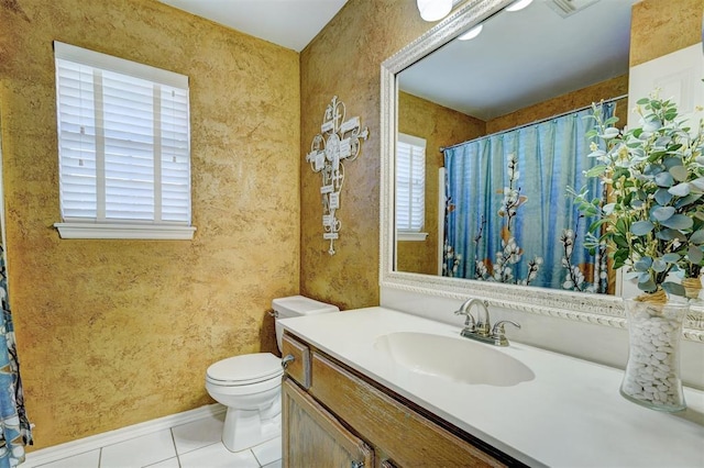 bathroom featuring vanity, tile patterned floors, and toilet