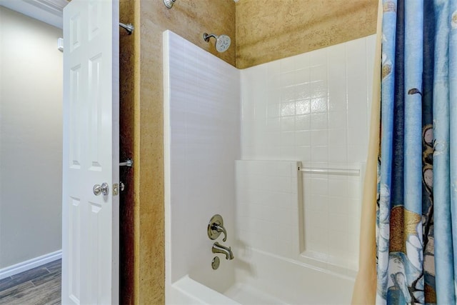 bathroom featuring hardwood / wood-style flooring and shower / bath combo