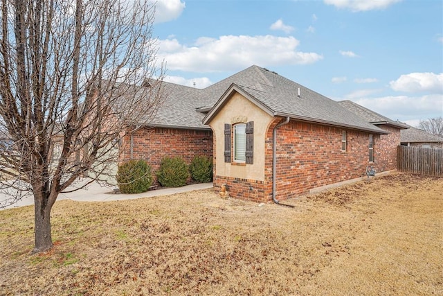 view of side of home featuring a lawn