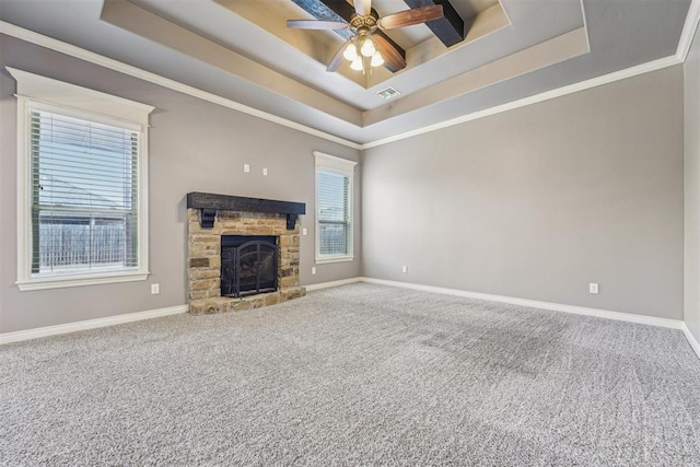 unfurnished living room featuring crown molding, a fireplace, a raised ceiling, and carpet flooring