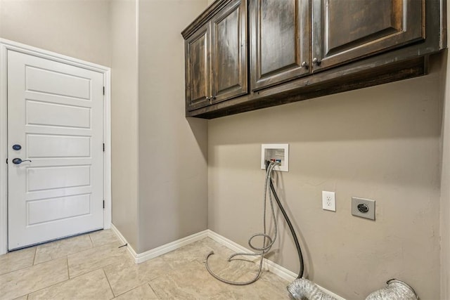 clothes washing area with washer hookup, cabinets, light tile patterned floors, and hookup for an electric dryer