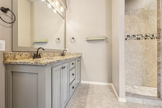 bathroom with vanity and a tile shower