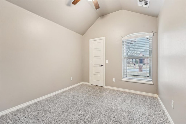 carpeted spare room featuring lofted ceiling and ceiling fan