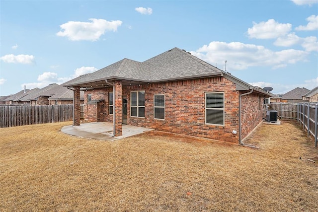 back of house with a lawn, central AC, and a patio area