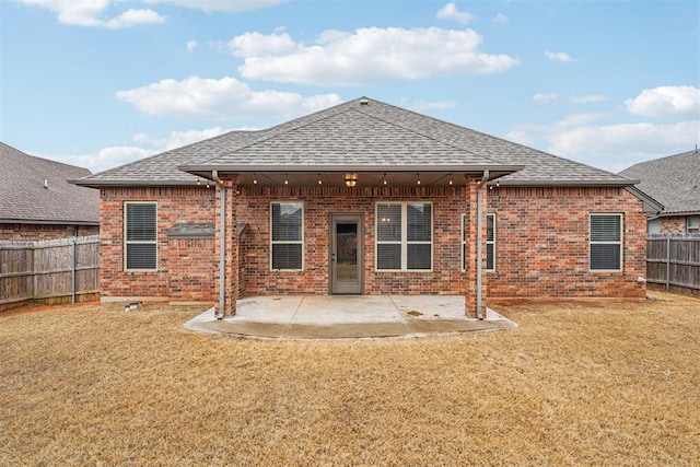 back of house with a yard and a patio