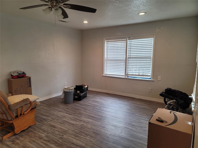 living area with dark hardwood / wood-style floors and a textured ceiling