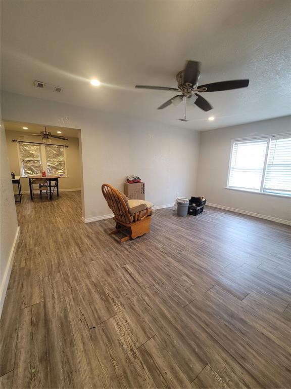 unfurnished room featuring ceiling fan and dark hardwood / wood-style flooring