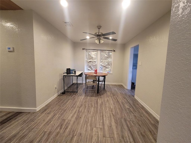 dining space featuring ceiling fan and dark hardwood / wood-style floors