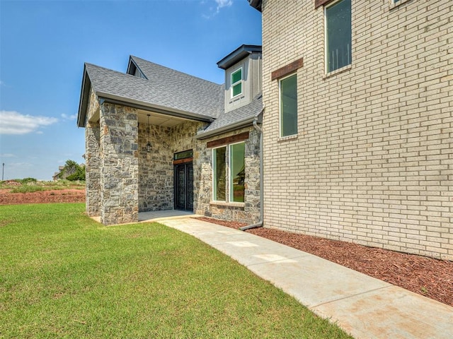 entrance to property with a lawn