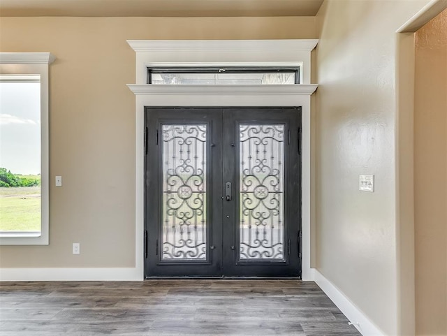 foyer with french doors and hardwood / wood-style floors