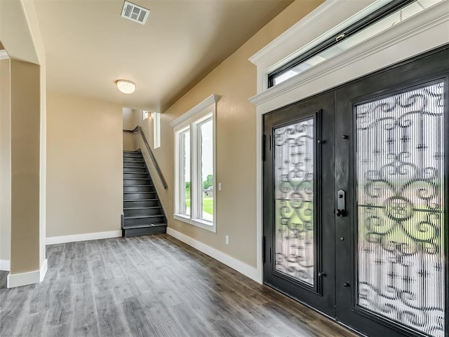 entrance foyer with hardwood / wood-style floors and french doors