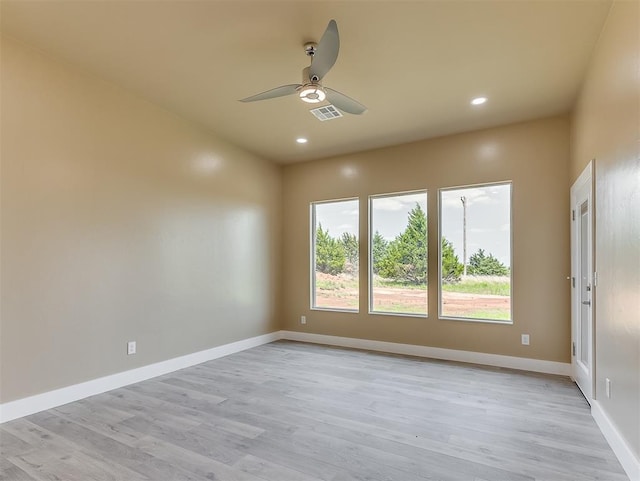 empty room featuring ceiling fan and light wood-type flooring