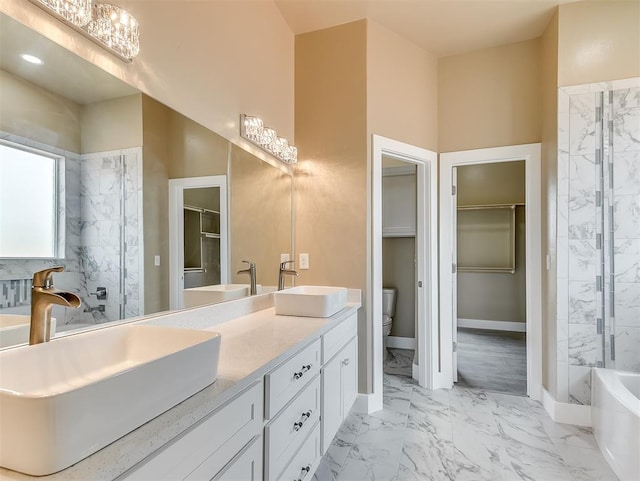 full bathroom with vanity, separate shower and tub, and toilet